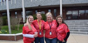 LRCC staff posing in tie-dye shirts in front of Turner Building