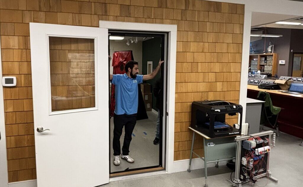 Weatherization instructor standing in a demo building