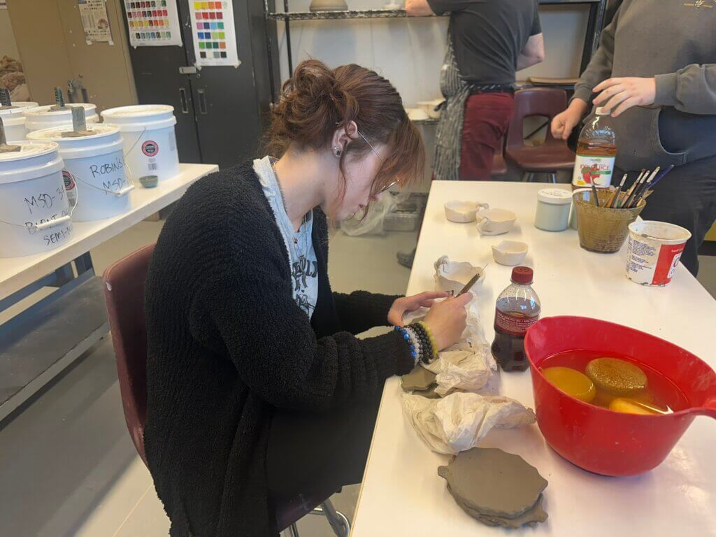 Student working on pottery project.