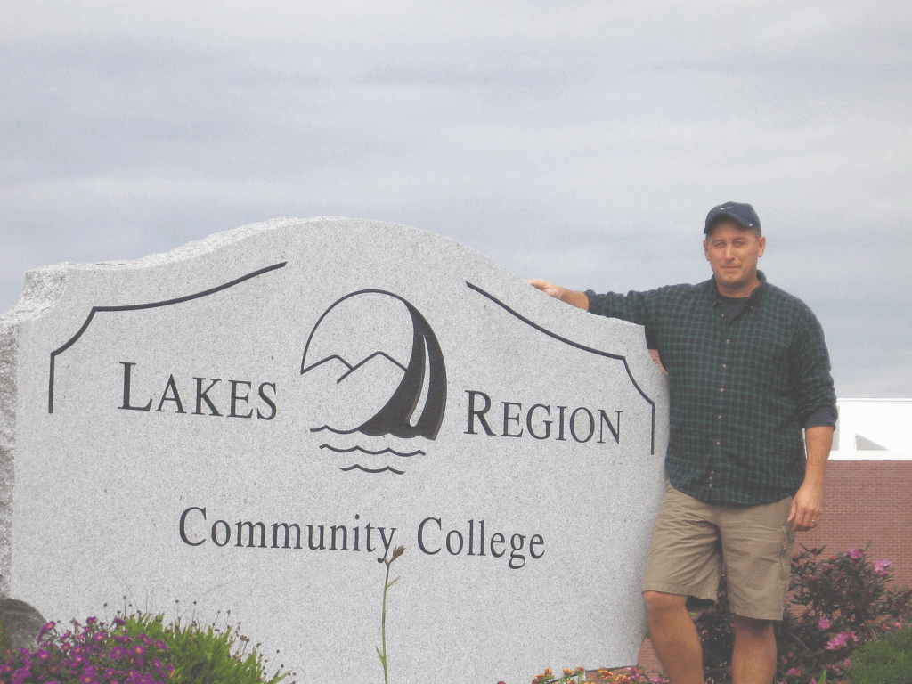 Bruce Langton standing next to the LRCC sign