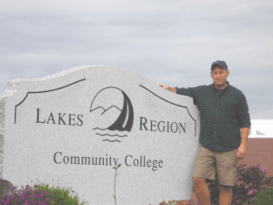 Bruce Langton standing next to the LRCC sign