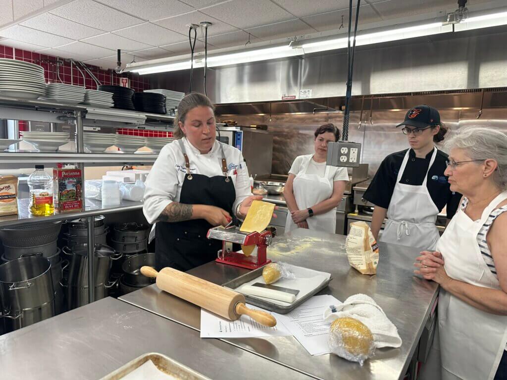 Students learning to roll pasta