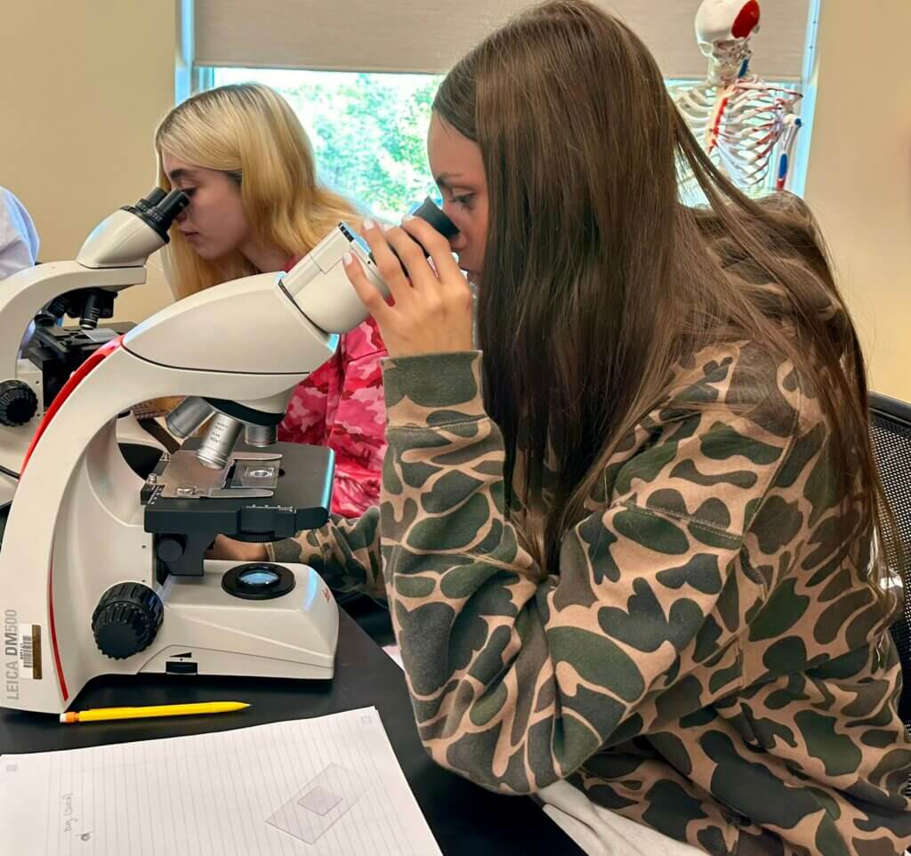 Students looking in microscopes