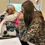 Students looking in microscopes